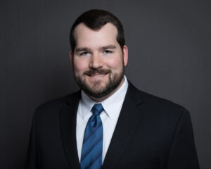 A headshot of newest member of NAP LLP, Justin Bishop